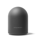 Dark gray cylindrical device with 'Steamery' branding on a white background