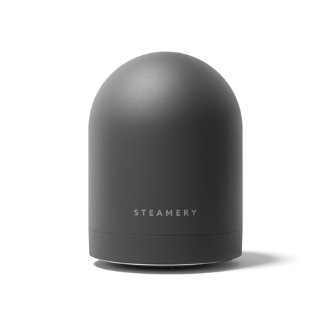 Dark gray cylindrical device with 'Steamery' branding on a white background